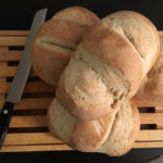 baked sourdough bread on bread board