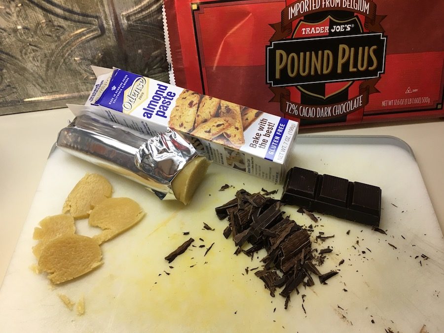 almond paste and chopped chocolate on a cutting board