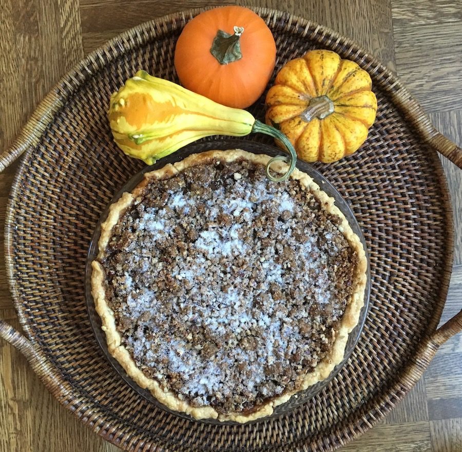 Praline Pumpkin Pie on tray with pumpkins overhead
