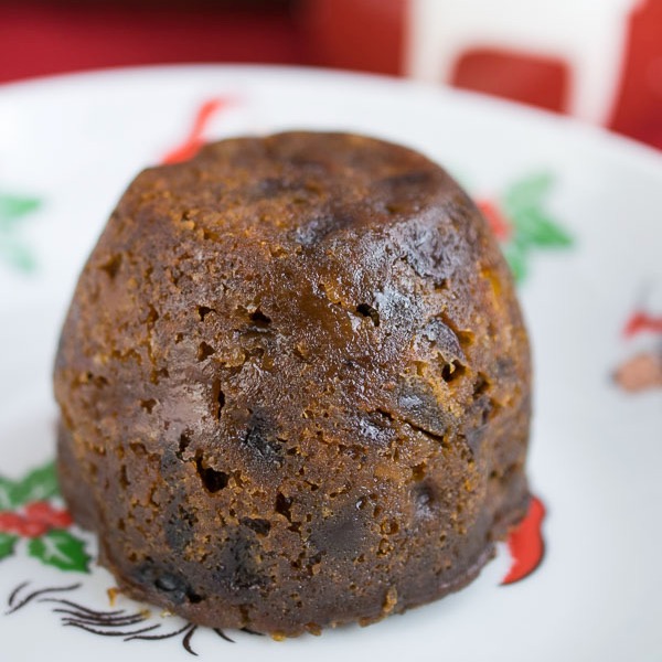 A traditional Christmas pudding plated closeup