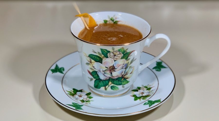 rum punch cocktail in china cup closeup wide