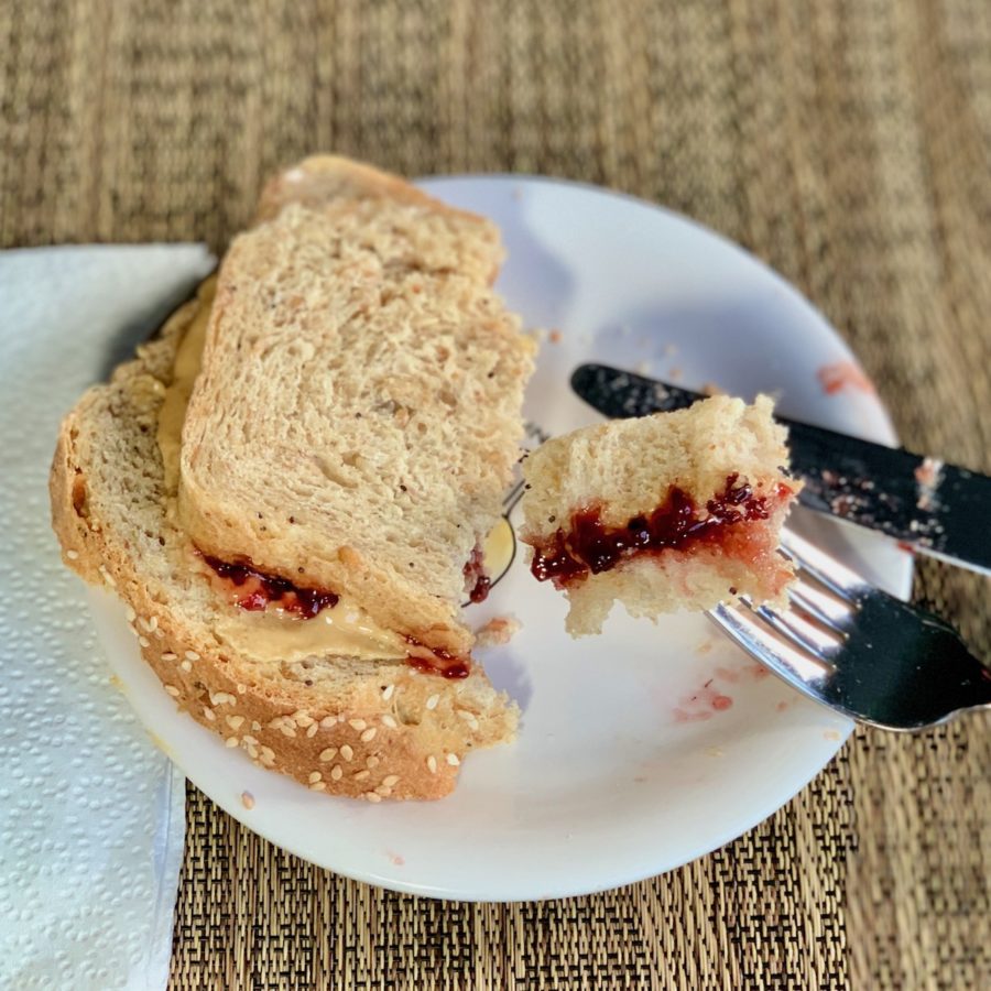 plated peanut butter & jelly sandwich with piece on fork