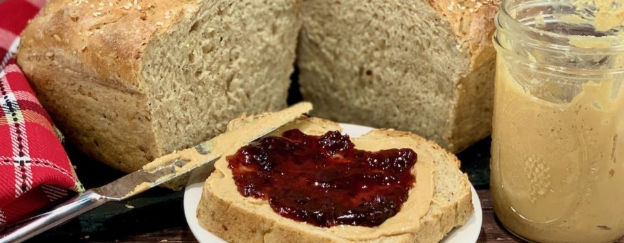 open face peanut butter & jelly sandwich with jar & loaf