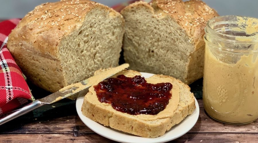 open face peanut butter & jelly sandwich with jar & loaf