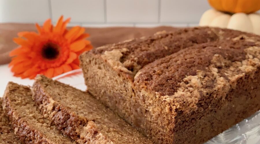 Sourdough Spice Cake sliced on plate with pumpkins closeup