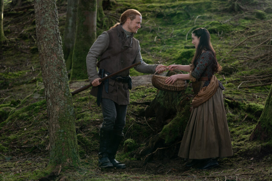Jamie takes Malva's basket to carry for her as they walk in the woods. 