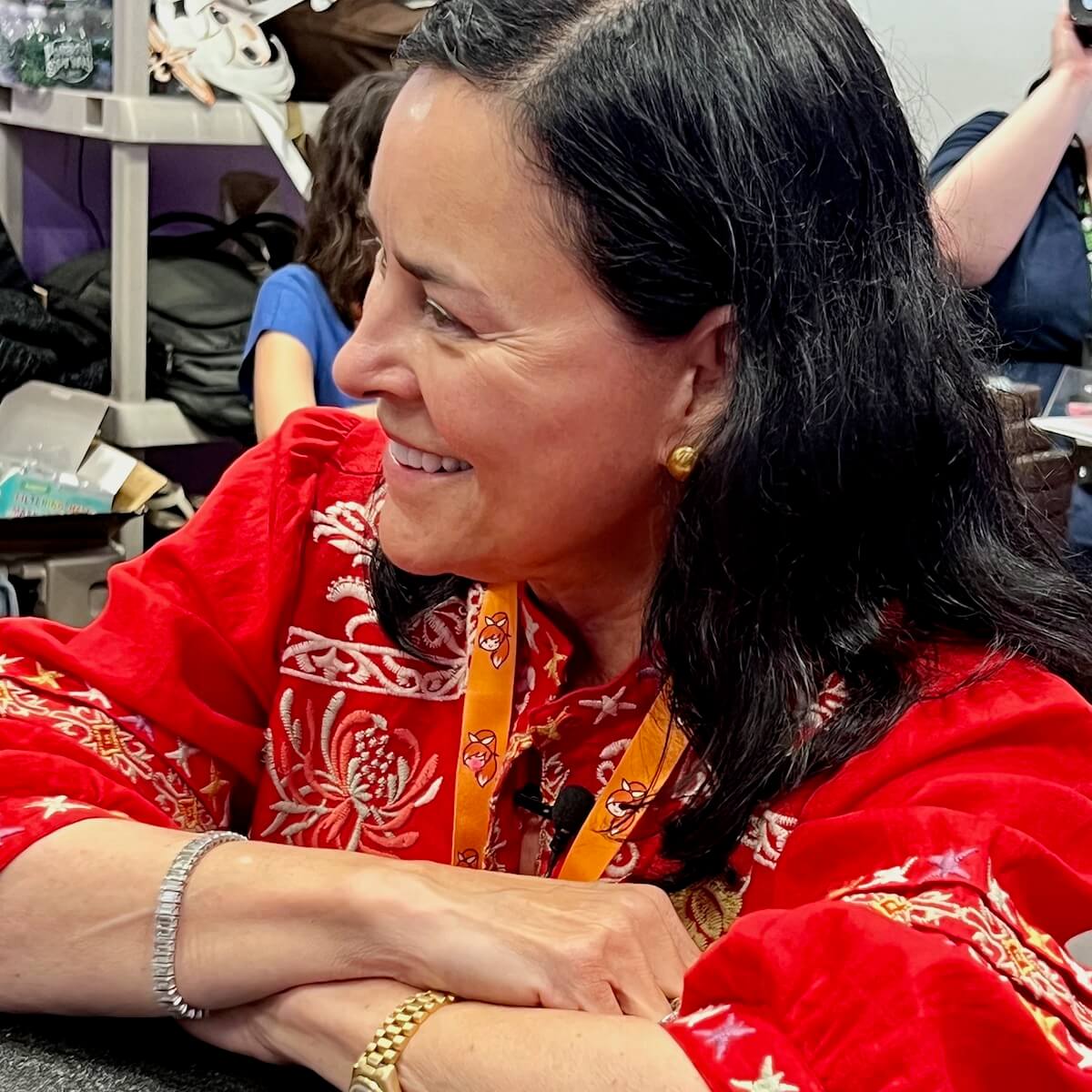 Diana Gabaldon sitting at a table for an interview.
